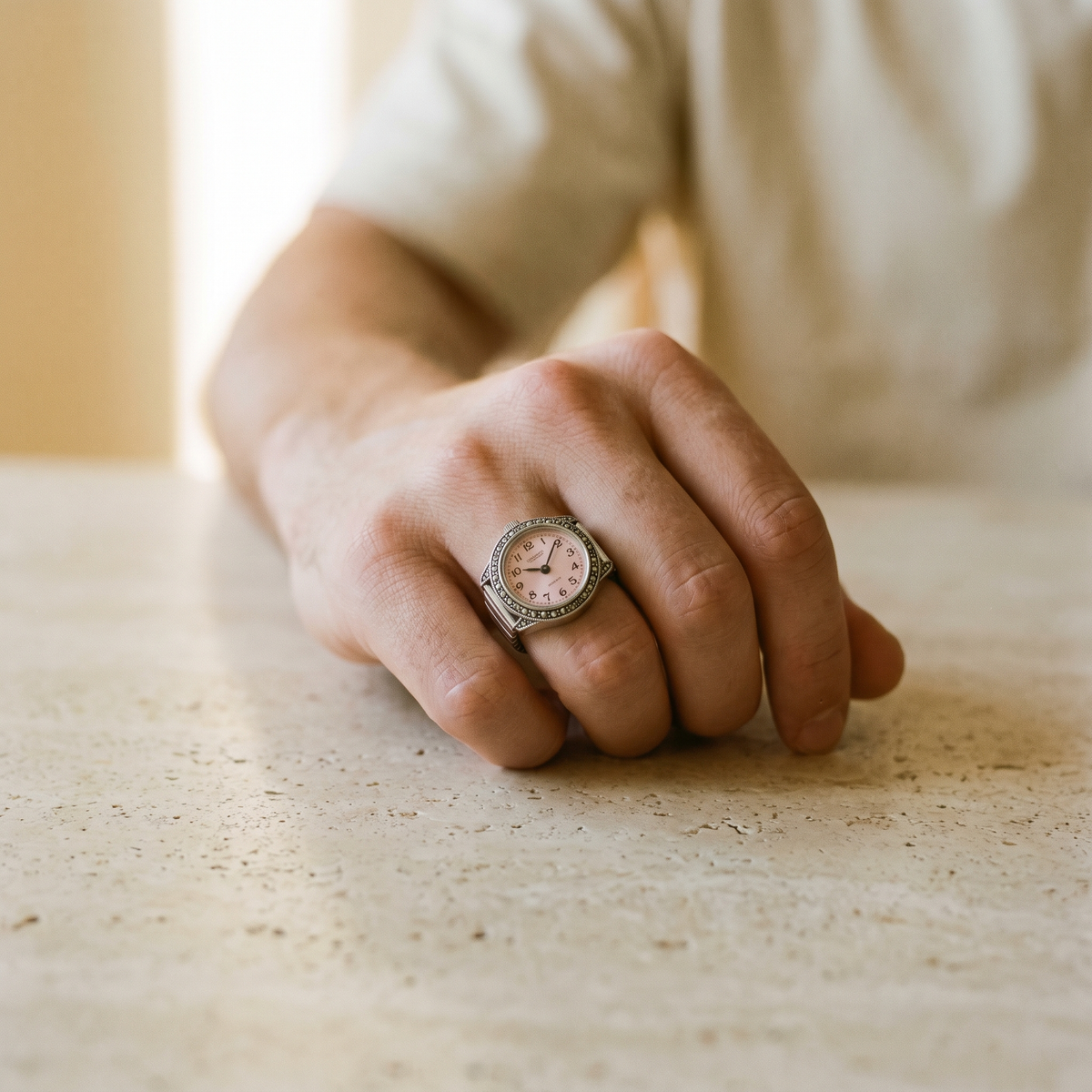 TIME — bague montre cadran rose portée à l'index